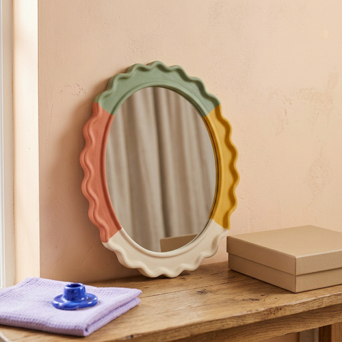 Ripple Mood mirror styled against a peach wall with lavender and cobalt accents